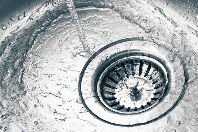 Soft water running in a stainless steel sink. 