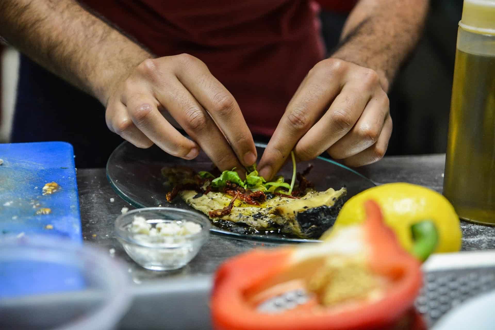 A chef preparing a meal at a restaurant.