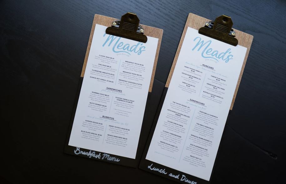 Two restaurant menus sit side by side on clip boards. These breakfast, lunch and dinner menus are simple, stylish menus for a positive and easy ordering experience for your patrons.
